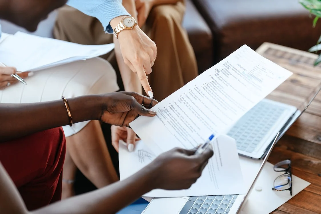 Close up photo of people reviewing documents.