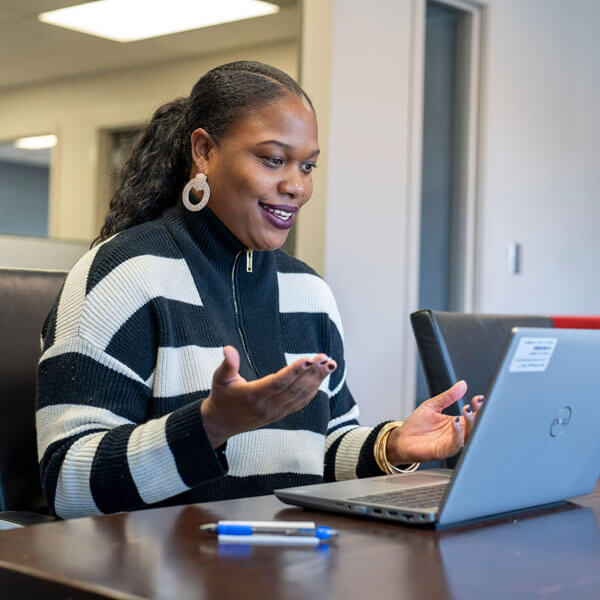 A woman on a laptop computer in a video conference.