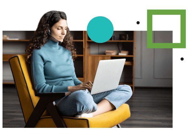 A woman sitting at home, reviewing HR management services from Employer Flexible on her laptop.